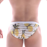 White mesh briefs by metromalewear featuring a vibrant yellow lemon print with green leaves and black accents