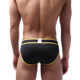 Black briefs with bold yellow trim and white metroMalewear brand tag at waistband swim brief style