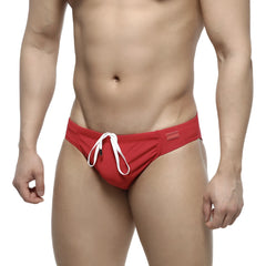 Red swim trunks by MetroMaleWear featuring a white drawstring and rectangular brand tag on the waistband