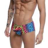 Metro male wear cannon boxer neon swim trunks with vibrant multicolored leopard-print and pink blue yellow gradient design