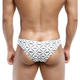 White swim trunks with bold black geometric and mustache pattern featuring nassim logo metroMalewear capri bikini caballero 6103-03