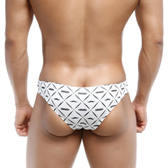 White swim trunks with bold black geometric and mustache pattern featuring nassim logo metroMalewear capri bikini caballero 6103-03
