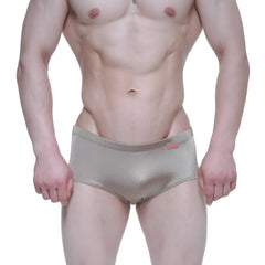 Shiny metallic gold MetroMaleWear Charlie swim briefs with subtle texture and small red brand tag on waistband