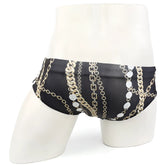 Black swim trunks by MetroMaleWear with bold gold and silver chain pattern and circular medallions for classic style