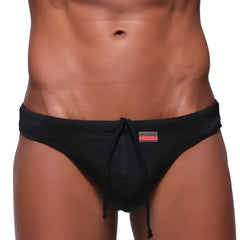 MetroMaleWear classic swim thong black 4902-20 features black drawstring trunks with textured fabric and small red waistband logo