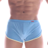 Light blue men’s briefs with cream trim and small red metro male wear brand tag on waistband for comfort and style