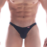 Black men’s thong MetroMaleWear dangerous jock strap black with small red logo on waistband shown from back side