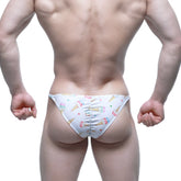 White swim trunks by MetroMaleWear featuring a playful colorful ice cream cone and sprinkle pattern