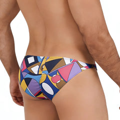 Vibrant geometric-patterned swim trunks in bold blues yellows pinks and purples from metromalewear fantasy bikini picasso 6116-87