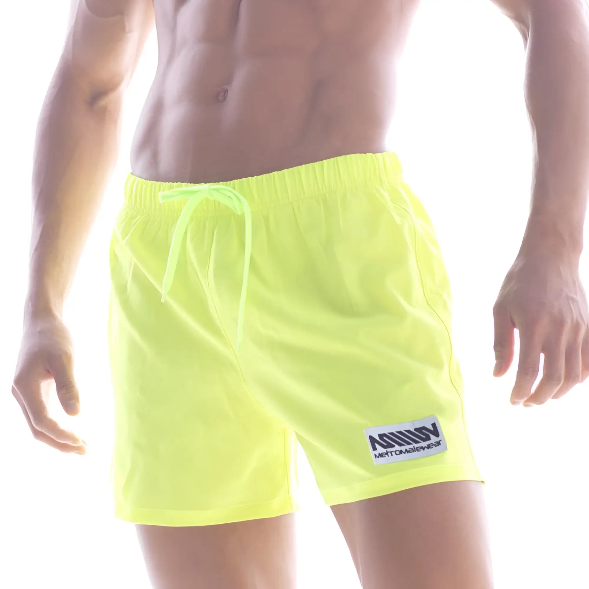 Neon yellow metro male wear flexible swim trunk with matching drawstring and white logo patch on lower left leg