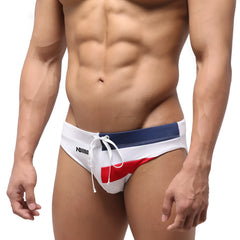 White metro malewear french swim brief with navy blue red accents and drawstring waistband featuring anna branding