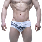 White metro male wear swim trunks with black Greek key waistband and small mew logo on the side