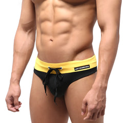 Black and yellow MetroMaleWear halfback swim bikini with drawstring waistband and branded label visible