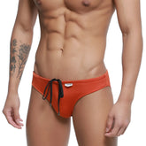 MetroMaleWear hunter swim brief ochre 4977-13 orange swim trunks with black drawstring ties and a white brand tag