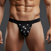 Black MetroMaleWear Kiss jock strap with white lip print pattern featuring a thong design for bold comfort and style
