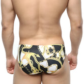 MetroMaleWear Lujo bikini black swim trunks with bold gold and white anchor and chain pattern for men