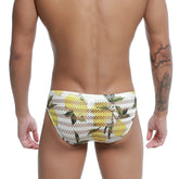 White mesh swim trunks with vibrant yellow lemon and green leaf pattern from metromalewear mango bikini 5103-36