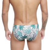 White swim trunks with vibrant teal and dark gray tropical leaf pattern metroMalewear Meadow Bikini 5103-56