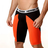 Black and orange mesh athletic shorts with white waistband featuring million branding metro malewear 15 inch long short