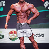 Gray and white metromalewear cordobaphysique board short with black drawstring and shield logo on left leg