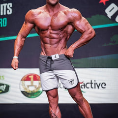 Gray and white metromalewear cordobaphysique board short with black drawstring and shield logo on left leg