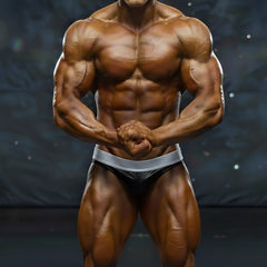 A muscular male bodybuilder wearing black and silver metro musclwear diy competition briefs by metromalewear