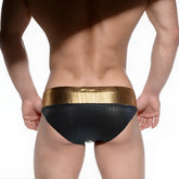 Black swim trunks with textured crocodile pattern and shiny gold waistband metro malewear fortuna competition suit
