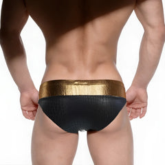 Black swim trunks with textured crocodile pattern and shiny gold waistband metro malewear fortuna competition suit