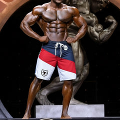 MetroMalewear MetroMuscleWear IFBB pro mens physique board short with blue red white stripes and black bull logo