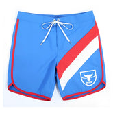 Blue swim trunks with red and white diagonal stripes, white drawstring waistband, and m2w logo patch on lower right leg by MetroMaleWear