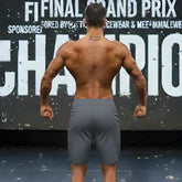 Gray charcoal MetroMaleWear MetroMuscleWear Insignia Physique athletic board shorts worn by a muscular man