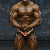A muscular man wearing metro musclewear mark competition suit cobalt briefs in black and copper colors