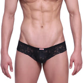 Black lace thong MetroMaleWear micro cheek lace with delicate floral pattern and red brand tag on waistband