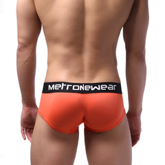 Bright orange microfiber men’s briefs with black waistband and white metronewear logo metro malewear mini boxer