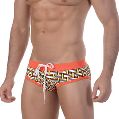 Orange swim trunks with a white and yellow geometric weave pattern and matching waistband and drawstring by MetroMaleWear