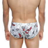 White swim trunks metro male wear oscar boxer escobar 2125-09 with bold floral pattern black outlines and red accents