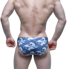 Blue swim trunks by metromalewear featuring a white wave pattern ideal for beach and pool use