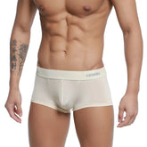 Cream-colored form-fitting men’s boxer briefs with a subtle gray logo on the waistband from metromalewear pastel trunk nude 2026-80