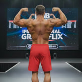 A muscular man shows the back side of metroMalewear physique board short crimson 4706-13 in bright red athletic fabric
