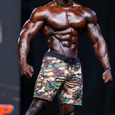 Metro malewear physique board short green camo with black drawstring waistband and logo patch on lower right leg