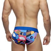 Vibrant geometric-patterned metroMalewear picasso bikini swim trunks with bold blue waistband for casual beachwear