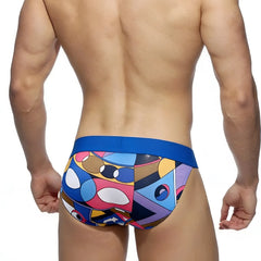 Vibrant geometric-patterned metroMalewear picasso bikini swim trunks with bold blue waistband for casual beachwear
