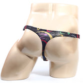Black MetroMaleWear Pinaculo thong with vibrant yellow red and green abstract swirls showing front side
