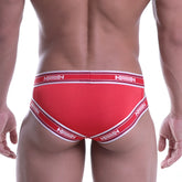 Red metroMalewear power mesh hip brief with white trim and repeating milliv logo on waistband and leg openings
