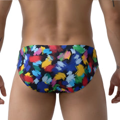 MetroMalewear primavera bikini 5103-M84 swim trunks with vibrant abstract brushstroke pattern in red blue yellow and green on black base