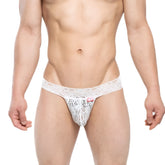 MetroMalewear reina g-string white lace thong with intricate floral patterns and a small red tag on the front