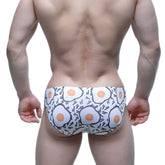 White swim trunks with playful cartoon fried egg pattern by MetroMaleWear Sunny Side Bikini 5103-M55