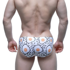 White swim trunks with playful cartoon fried egg pattern by MetroMaleWear Sunny Side Bikini 5103-M55