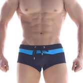Navy blue MetroMaleWear swim trunks with bright blue horizontal stripe and black drawstring ties for swimming
