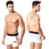 White athletic briefs metro malewear terry sport short with black waistband trim and orange logo on left leg